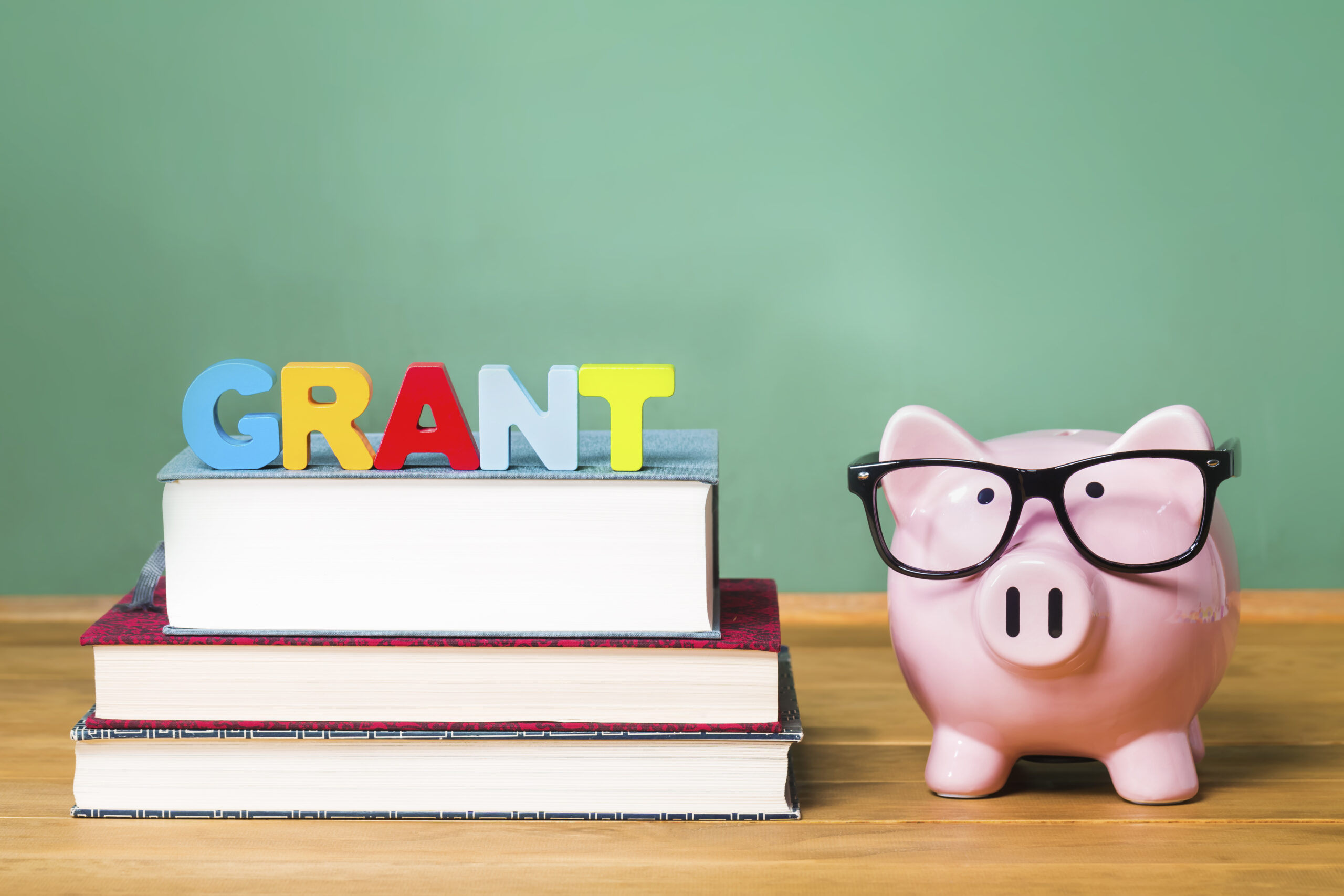 Educational,Grant,Theme,With,Pink,Piggy,Bank,With,Chalkboard,In